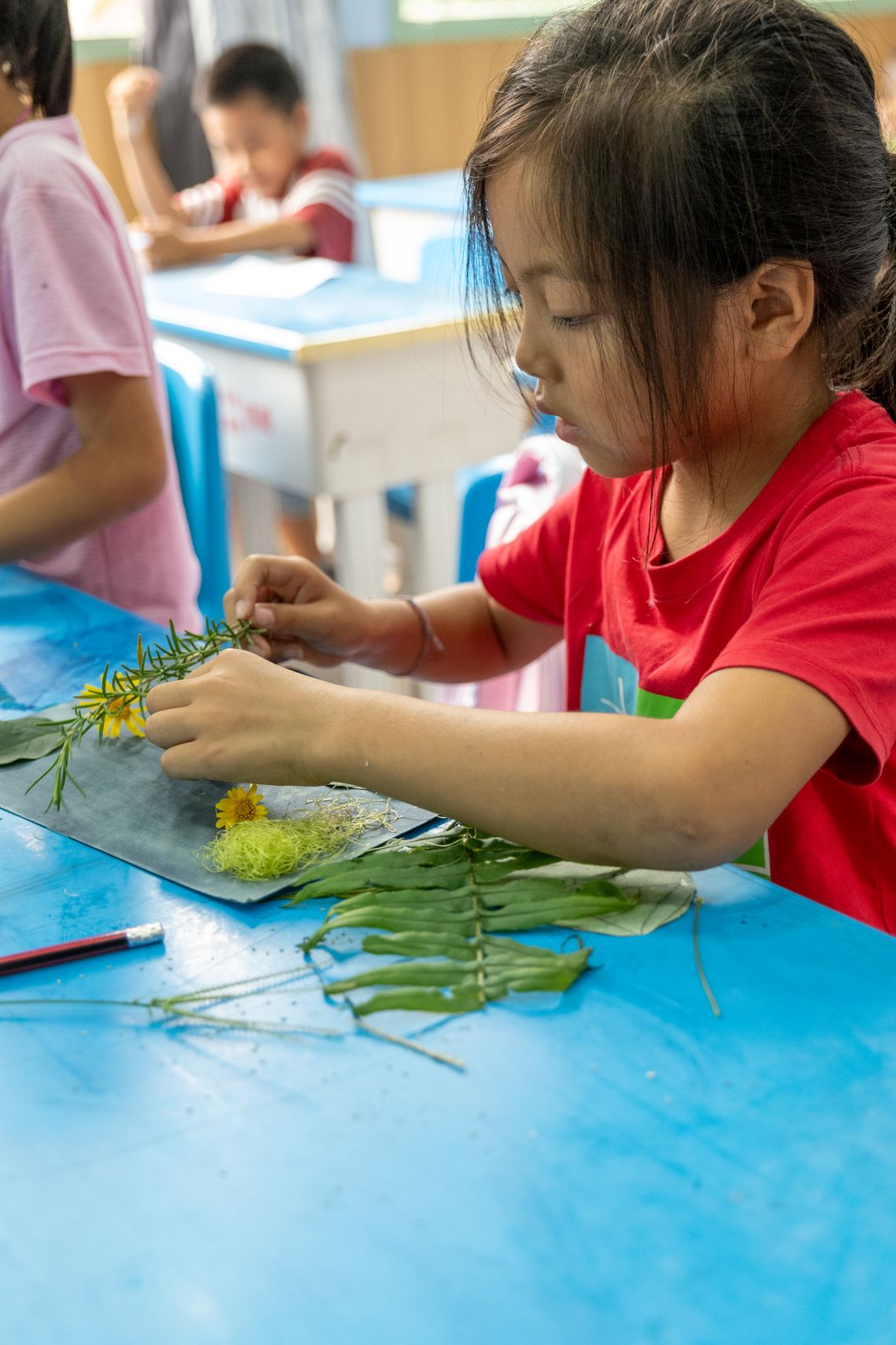 child arranging cyanotype patterns